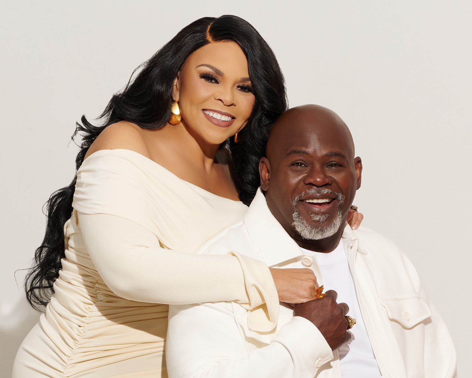 Tamela and David Mann in formal attire posing together against a plain background