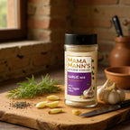 Mama Mann's Garlic Mix jar on a wooden cutting board with garlic and herbs in a kitchen setting